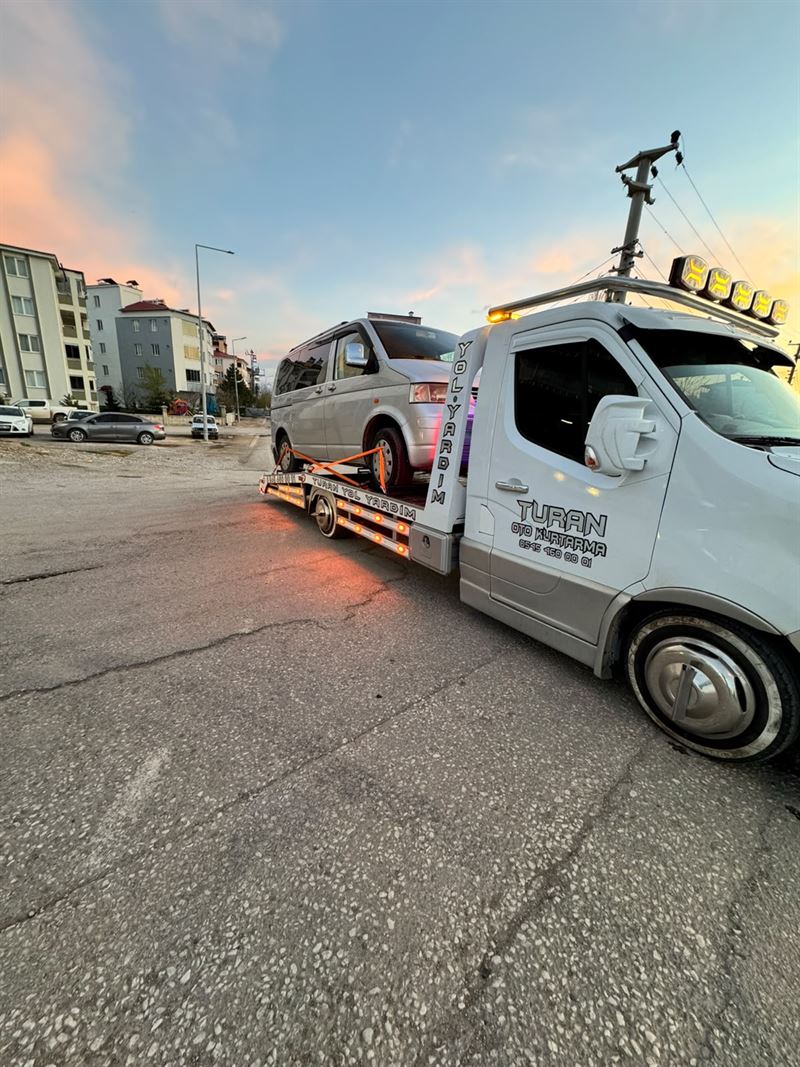 Gri SUV aracının akşam ışığında çekiciye yüklenmesi